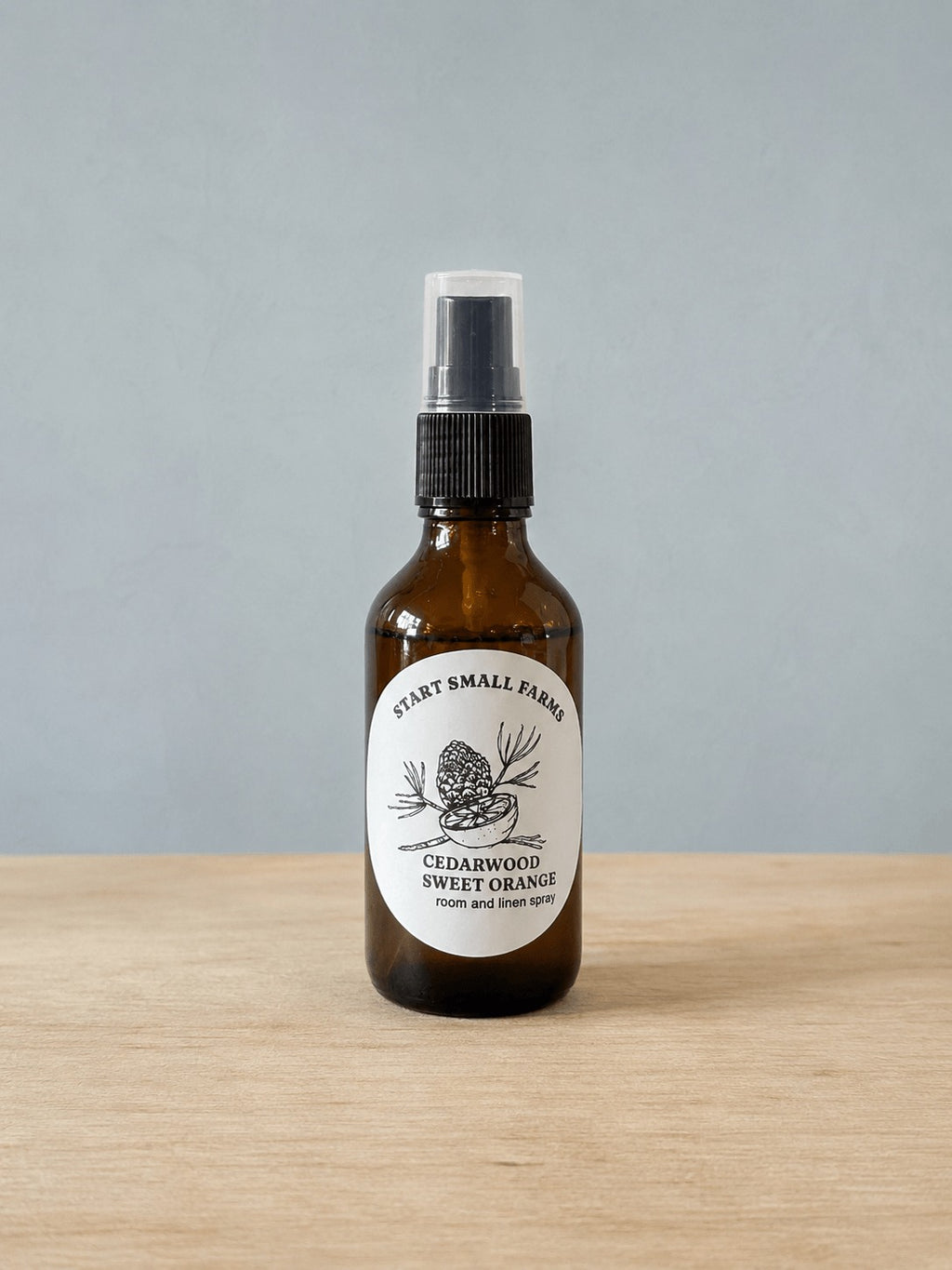 Room & Linen Spray in Cedarwood Sweet Orange, a 4oz amber glass bottle with a black spray top