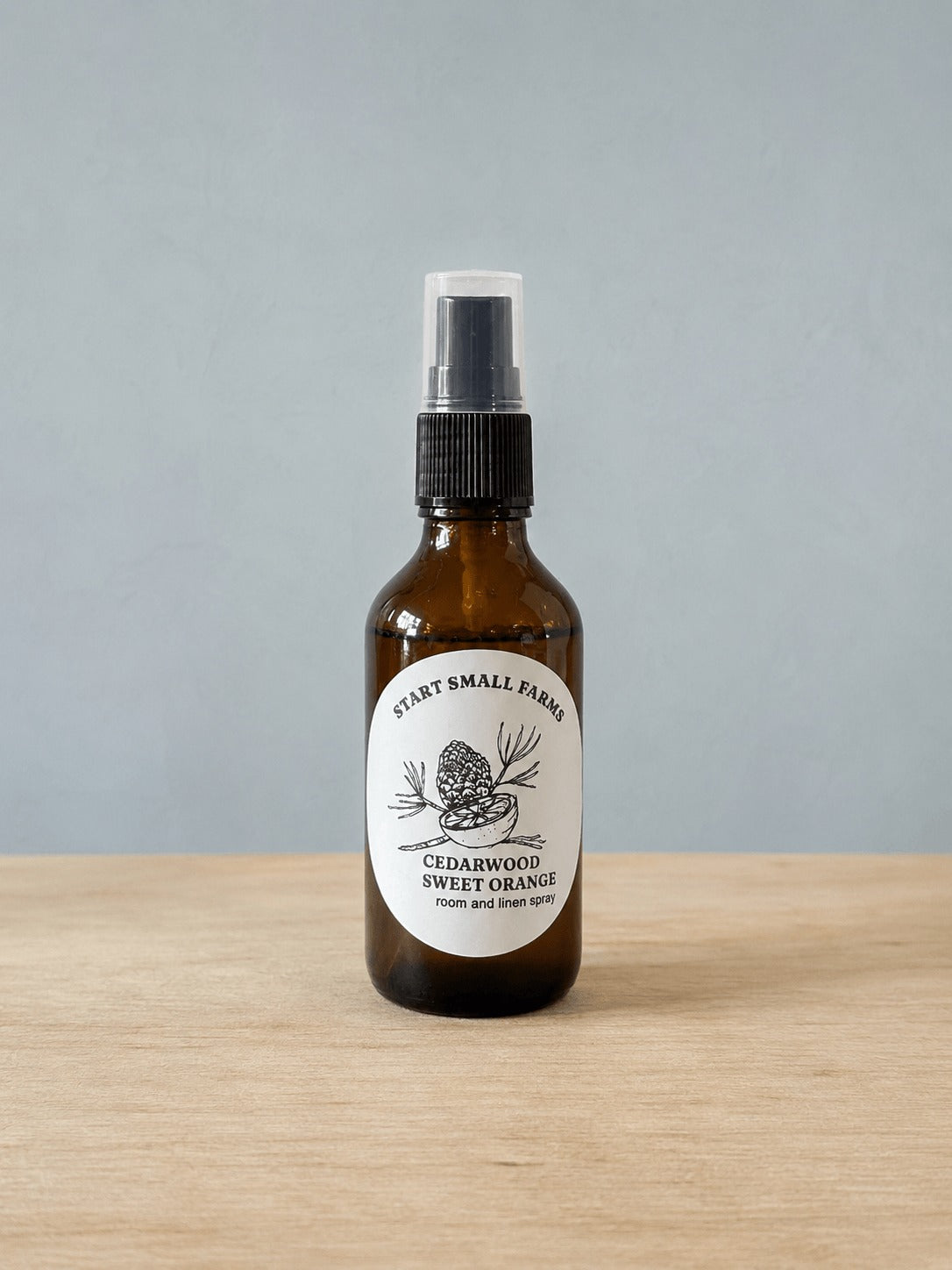 Room & Linen Spray in Cedarwood Sweet Orange, a 4oz amber glass bottle with a black spray top