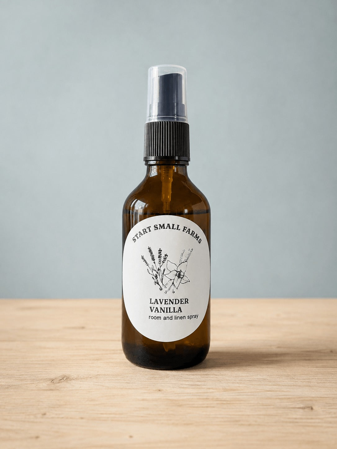Room & Linen Spray in Lavender Vanilla, a 4oz amber glass bottle with a black spray top