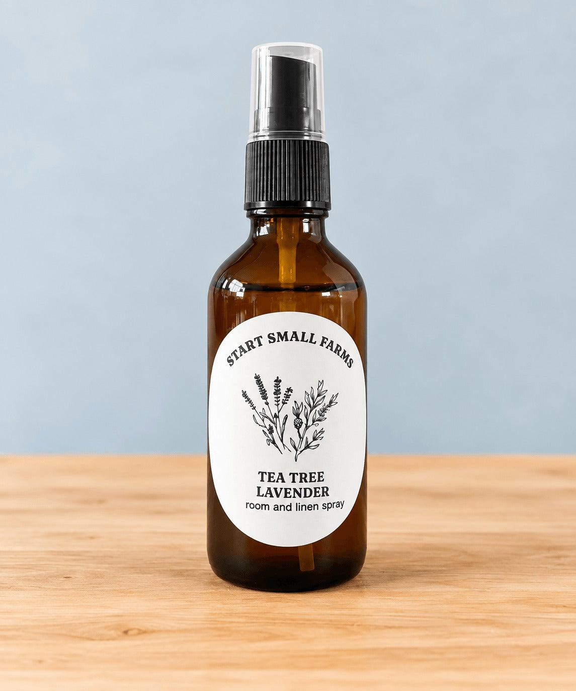 Room & Linen Spray in Tea Tree Lavender, a 4oz amber glass bottle with a black spray top