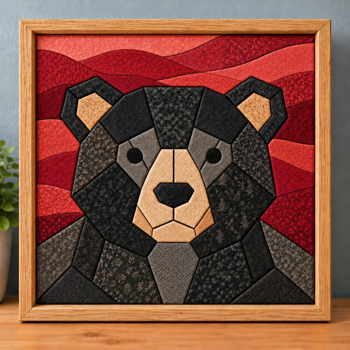 The same chunky black bear design in a natural wood frame, standing on a wooden shelf.