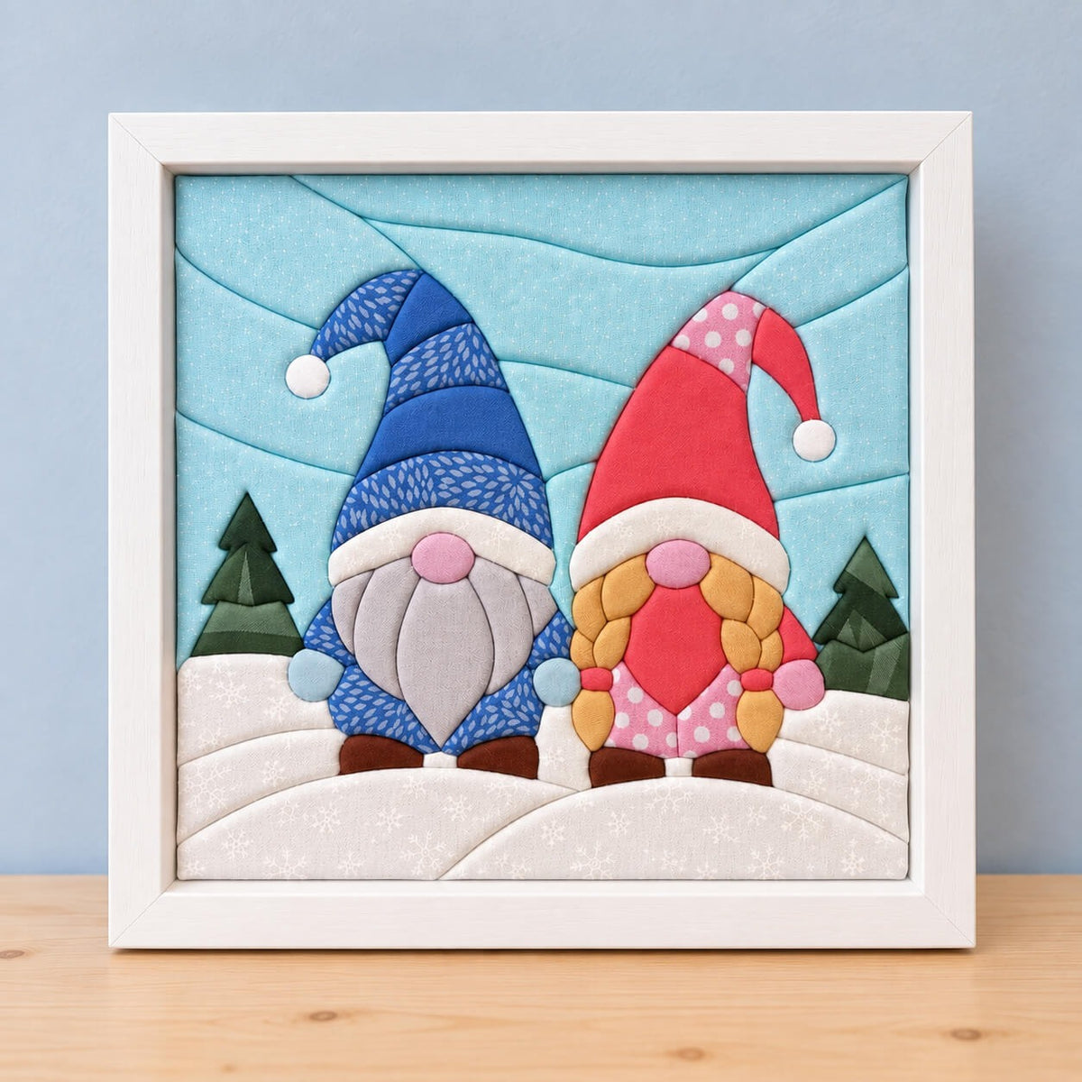 The same gnome design in a white frame, standing on a wooden shelf.