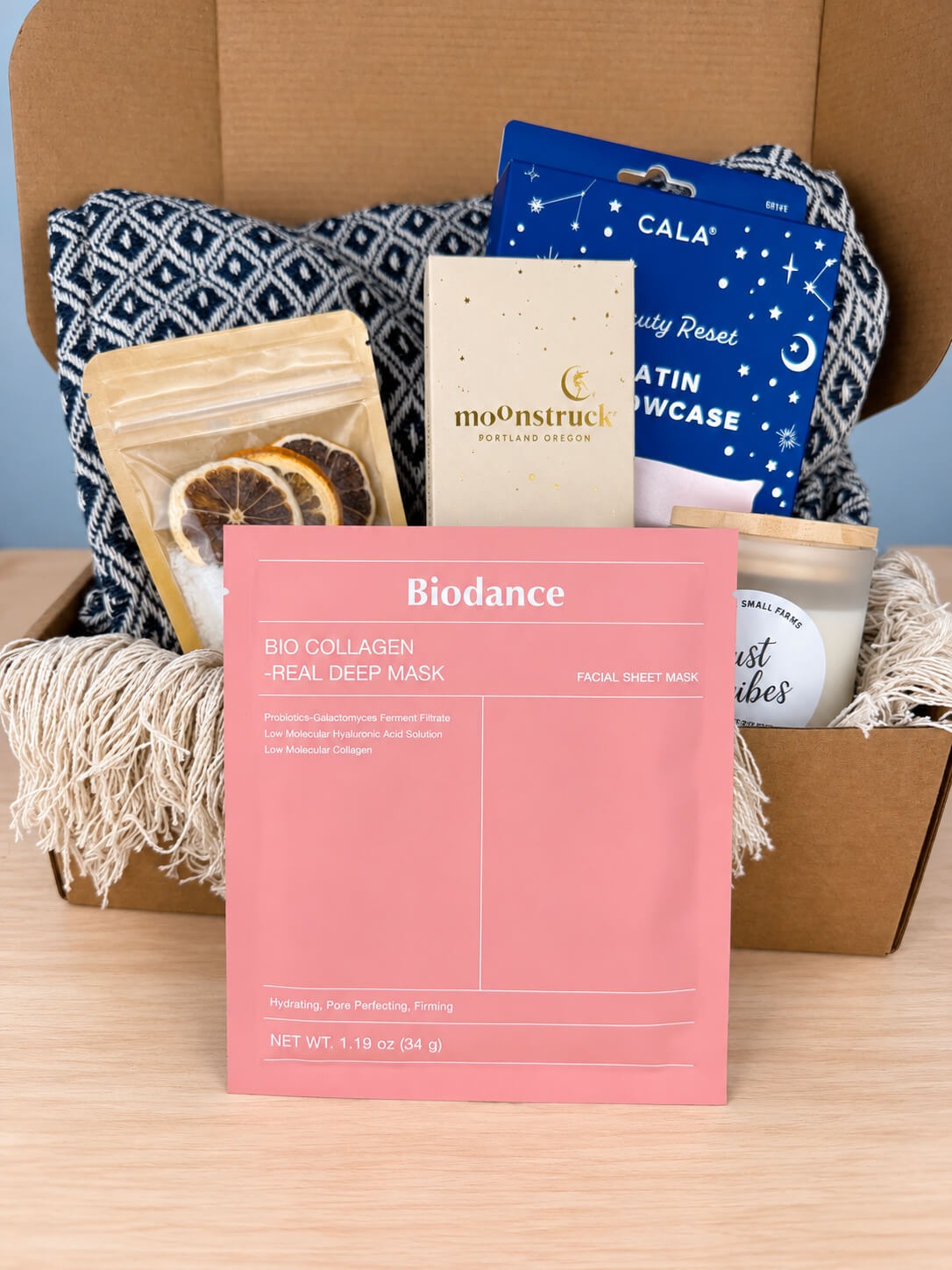 The Biodance Bio Collagen Real Deep Mask in its pink sachet, standing in front of the open box.