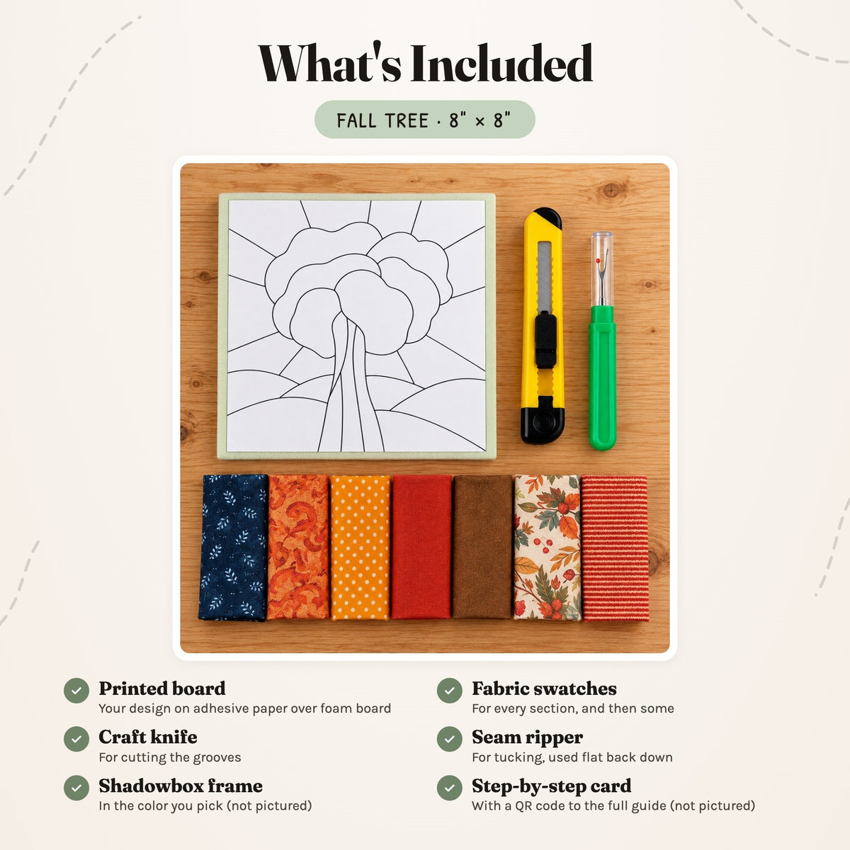 What's included in the Fall Tree kit, laid out on a wood table: the printed board, fabric swatches, a craft knife and a seam ripper. The shadowbox frame and the step-by-step card are not pictured.