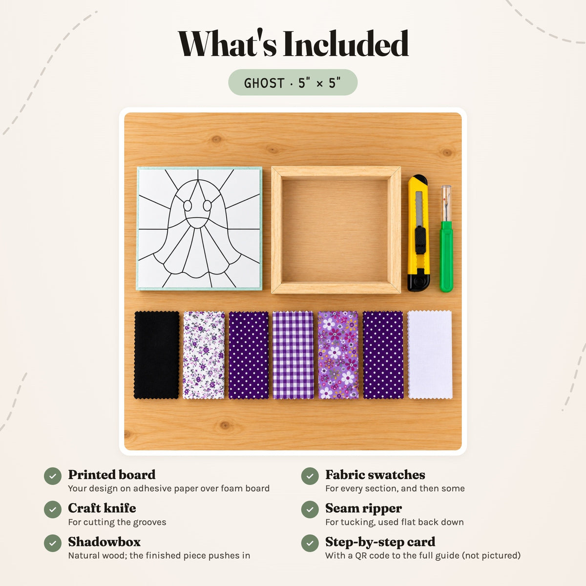 What's included in the Ghost kit, laid out on a wood table: the printed board, fabric swatches, a craft knife, a seam ripper and the natural wood shadowbox. The step-by-step card is not pictured.
