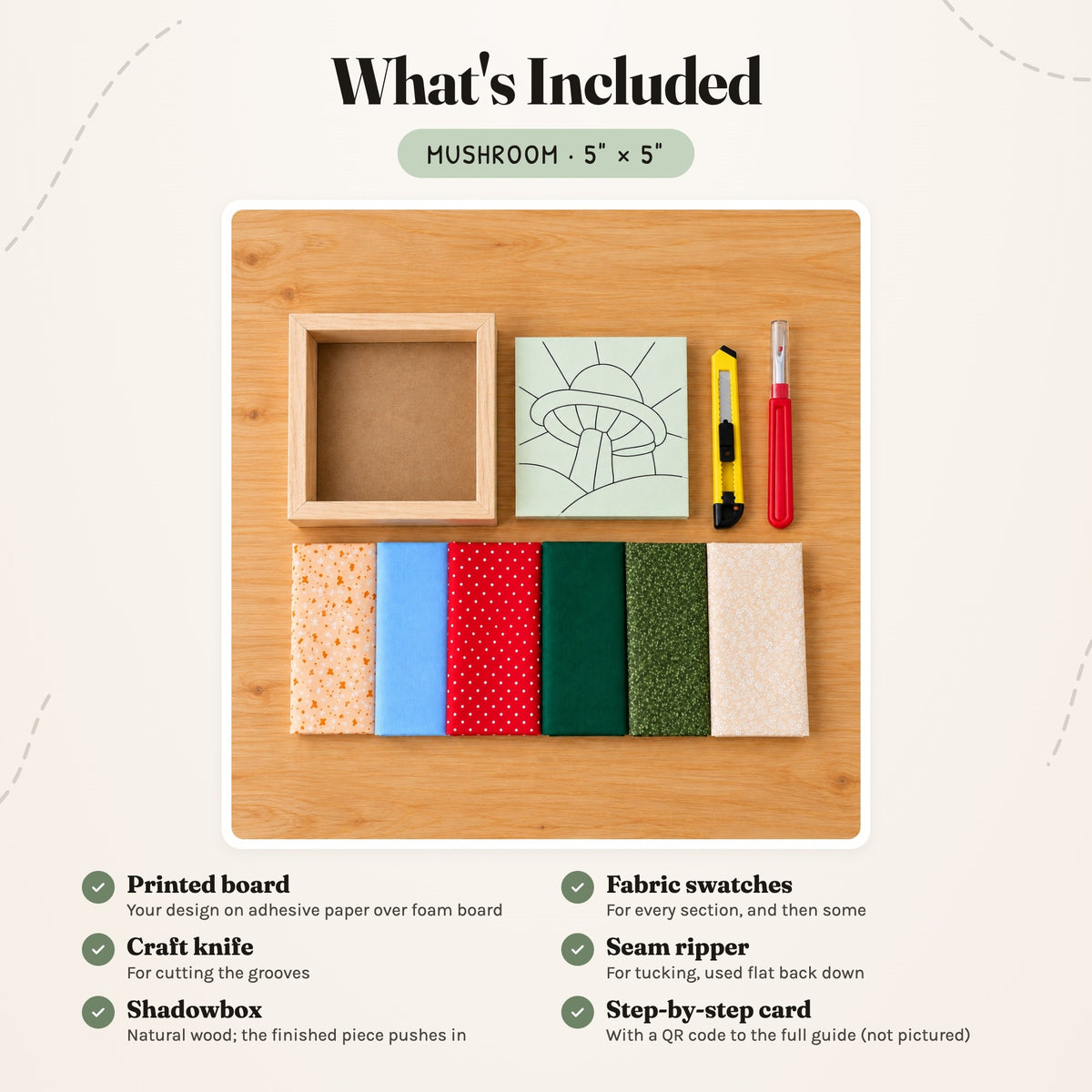 What's included in the Mushroom kit, laid out on a wood table: the printed board, fabric swatches, a craft knife, a seam ripper and the natural wood shadowbox. The step-by-step card is not pictured.