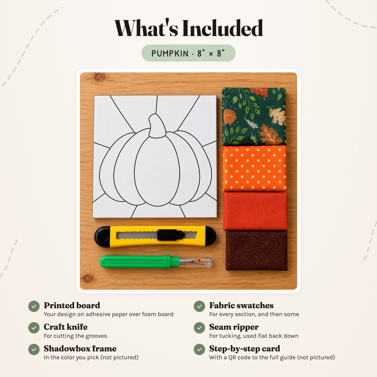 What's included in the Pumpkin kit, laid out on a wood table: the printed board, fabric swatches, a craft knife and a seam ripper. The shadowbox frame and the step-by-step card are not pictured.