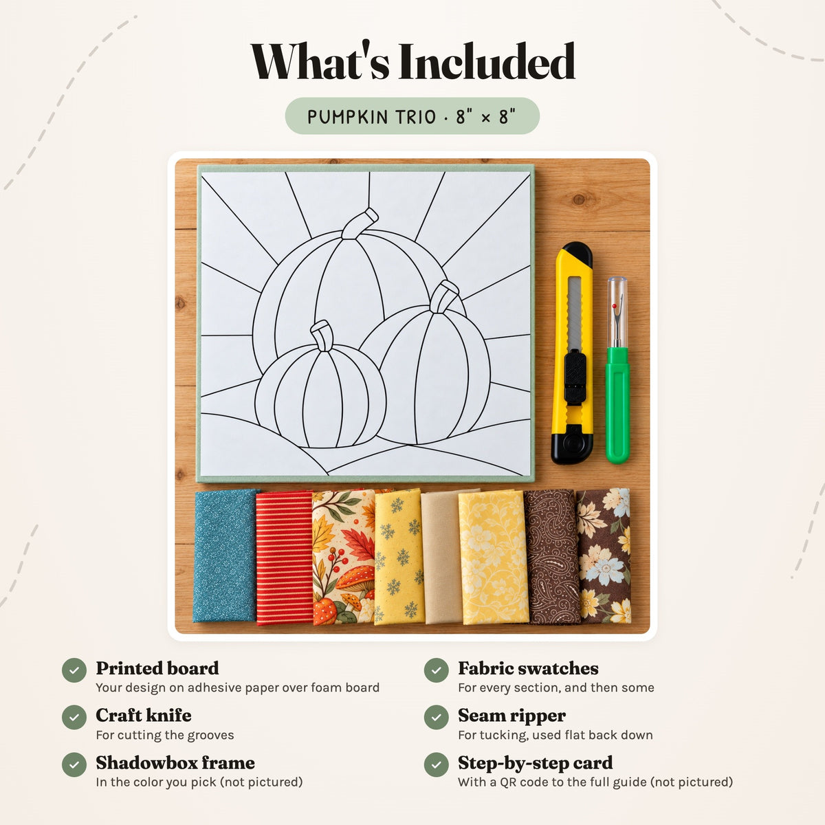 What's included in the Pumpkin Trio kit, laid out on a wood table: the printed board, fabric swatches, a craft knife and a seam ripper. The shadowbox frame and the step-by-step card are not pictured.