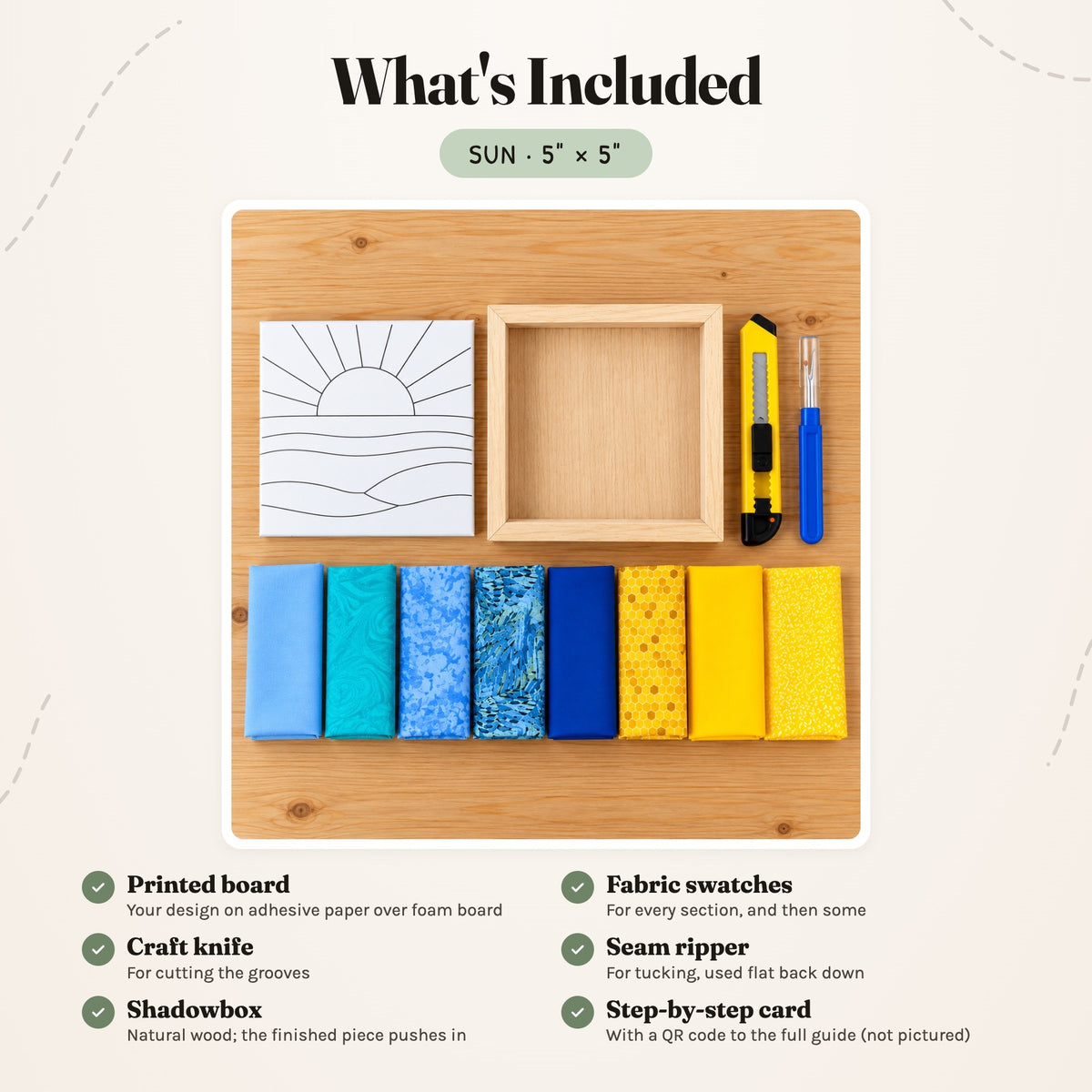 What's included in the Sun kit, laid out on a wood table: the printed board, fabric swatches, a craft knife, a seam ripper and the natural wood shadowbox. The step-by-step card is not pictured.