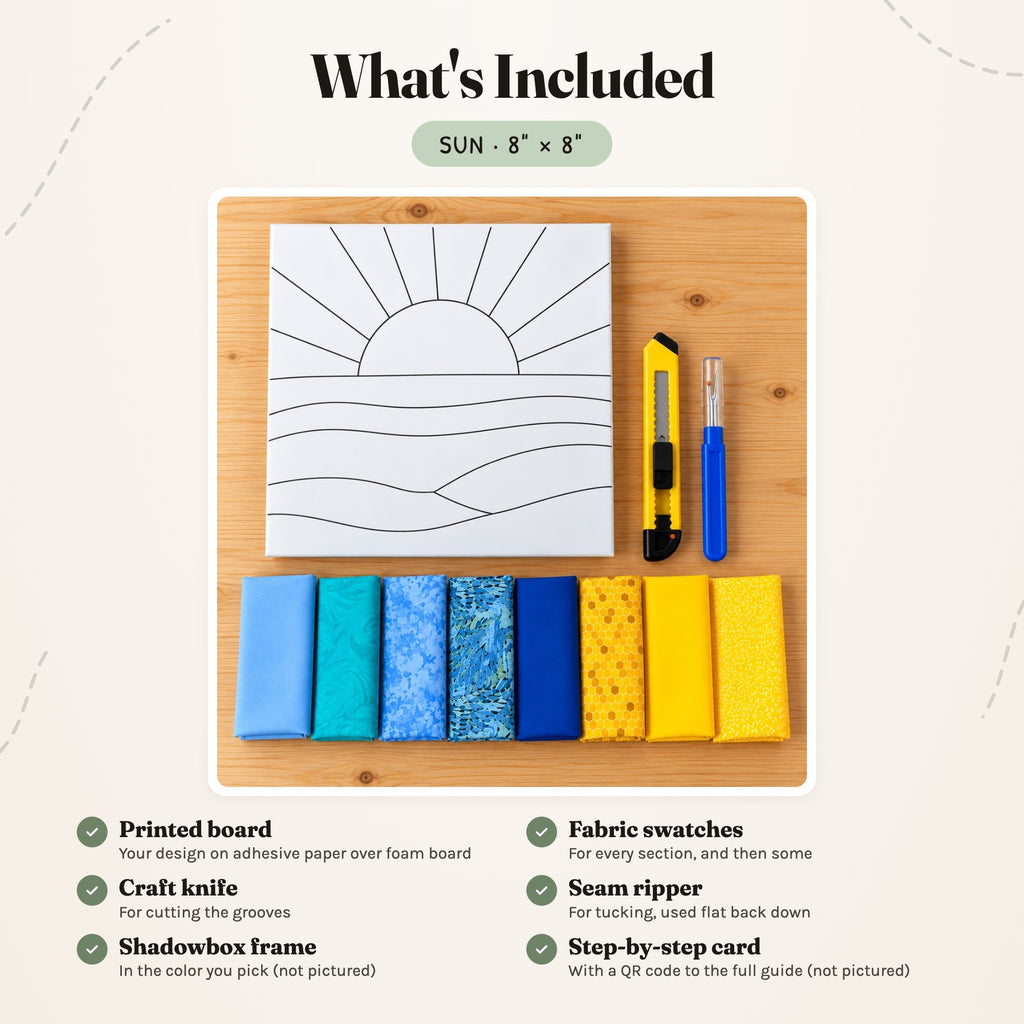 What's included in the Sun kit, laid out on a wood table: the printed board, fabric swatches, a craft knife and a seam ripper. The shadowbox frame and the step-by-step card are not pictured.