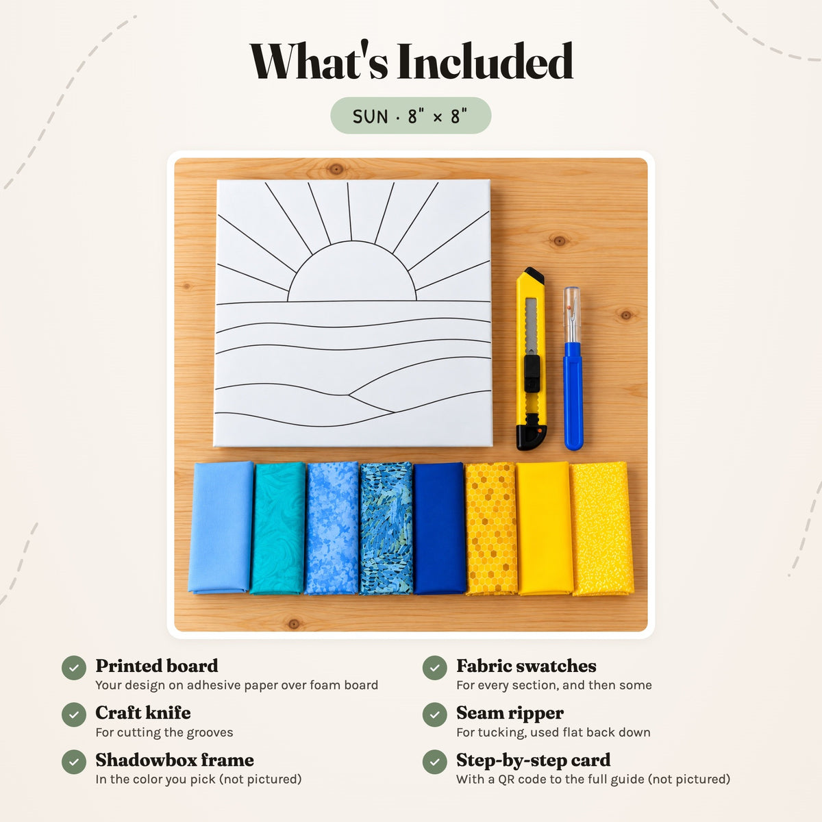 What's included in the Sun kit, laid out on a wood table: the printed board, fabric swatches, a craft knife and a seam ripper. The shadowbox frame and the step-by-step card are not pictured.