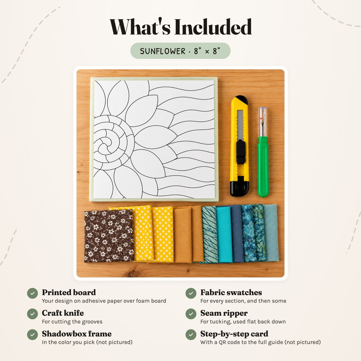 What's included in the Sunflower kit, laid out on a wood table: the printed board, fabric swatches, a craft knife and a seam ripper. The shadowbox frame and the step-by-step card are not pictured.